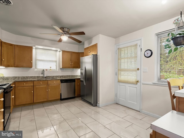 3807 24th Ave, Temple Hills, MD 20748 - kitchen with appliances with stainless steel finishes, a sink, a ceiling fan, and brown cabinets