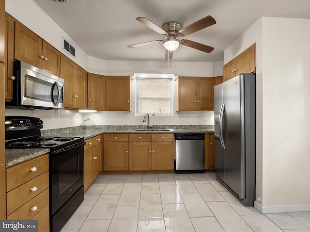 3807 24th Ave, Temple Hills, MD 20748 - kitchen featuring appliances with stainless steel finishes, a sink, brown cabinets, and ceiling fan