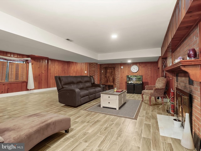 3807 24th Ave, Temple Hills, MD 20748 - living area featuring wooden walls, light wood finished floors, and a brick fireplace