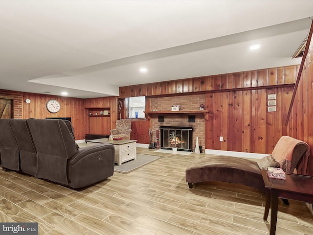 3807 24th Ave, Temple Hills, MD 20748 - living area featuring wood walls, light wood finished floors, and a brick fireplace