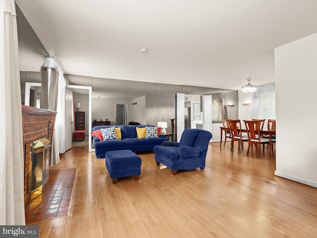 3807 24th Ave, Temple Hills, MD 20748 - living area with a brick fireplace, wood finished floors, and baseboards
