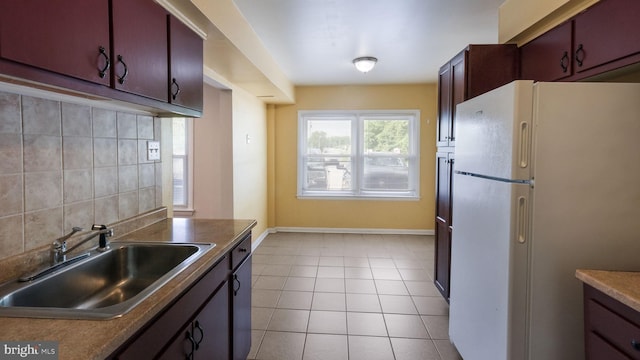 3119 Comly Rd, Philadelphia, PA 19154 - kitchen with freestanding refrigerator, a sink, decorative backsplash, light tile patterned floors, and baseboards