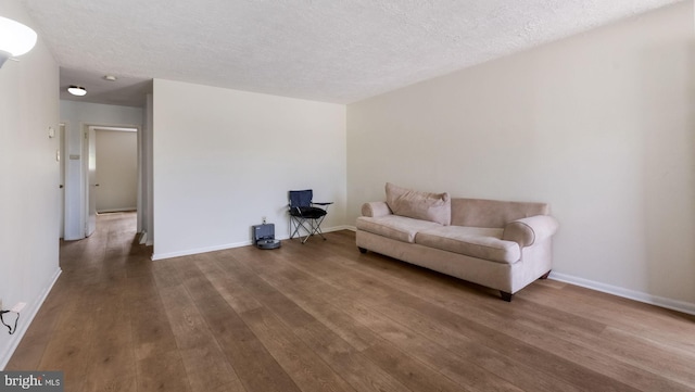 3119 Comly Rd, Philadelphia, PA 19154 - living area featuring wood finished floors, baseboards, and a textured ceiling