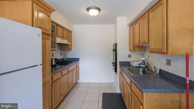 3119 Comly Rd, Philadelphia, PA 19154 - kitchen featuring freestanding refrigerator, under cabinet range hood, dark countertops, and backsplash