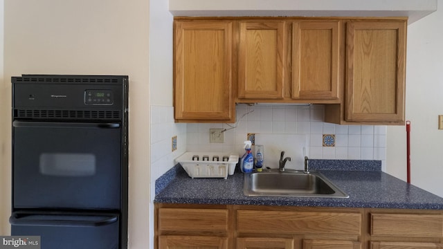 3119 Comly Rd, Philadelphia, PA 19154 - kitchen with a sink, black oven, a warming drawer, dark countertops, and tasteful backsplash