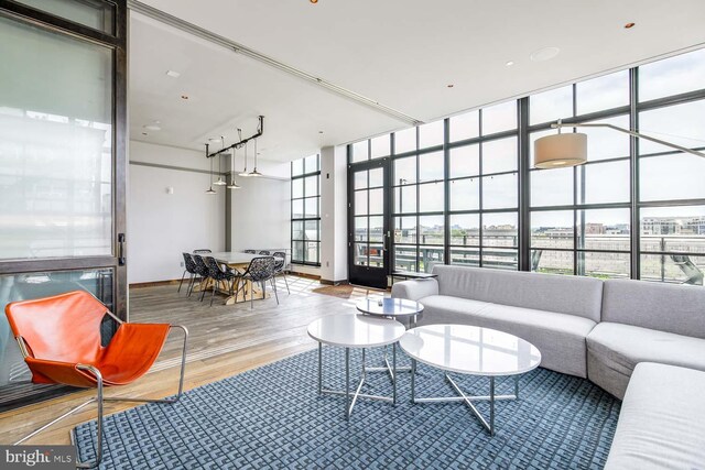2030 8th St NW Unit 513, Washington, DC 20001 - living area with wood finished floors, floor to ceiling windows, and baseboards