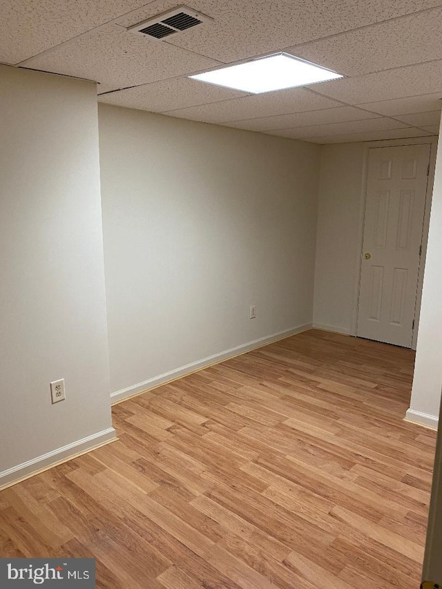 3299 Corcyra Ct, Woodbridge, VA 22192 - unfurnished room featuring a drop ceiling, light wood-type flooring, and baseboards