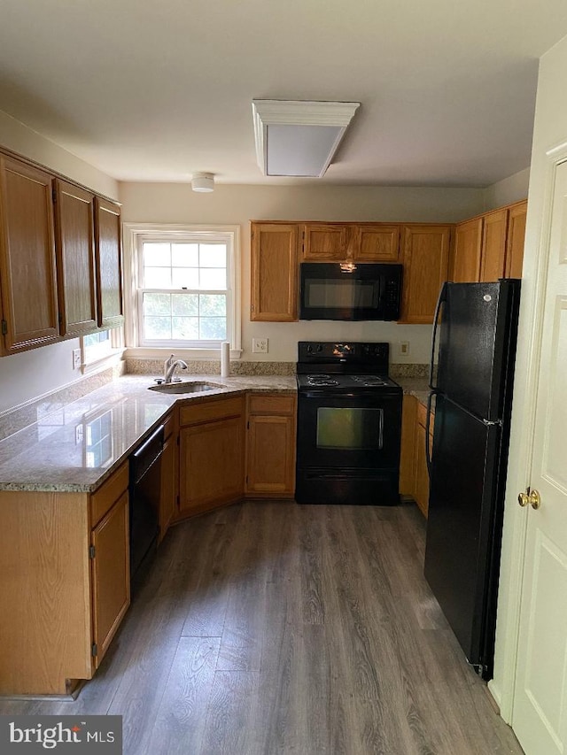 3299 Corcyra Ct, Woodbridge, VA 22192 - kitchen with black appliances, a sink, dark wood-style flooring, and brown cabinets