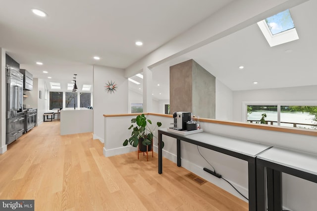 2201 Burgee Ct, Reston, VA 20191 - hall with a skylight, plenty of natural light, recessed lighting, light wood-style flooring, and baseboards