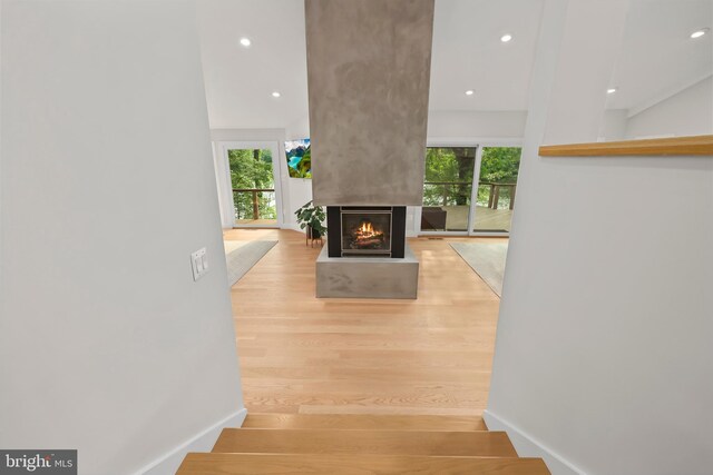 2201 Burgee Ct, Reston, VA 20191 - stairs featuring wood finished floors, recessed lighting, a multi sided fireplace, and baseboards