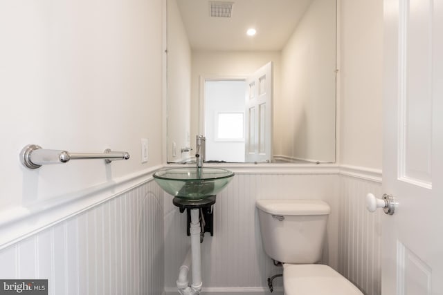 5312 Baltimore Ave, Chevy Chase, MD 20815 - bathroom featuring toilet, a wainscoted wall, and a decorative wall