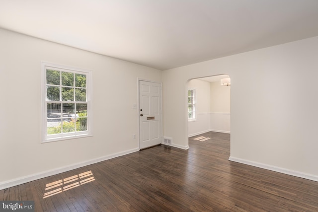 5312 Baltimore Ave, Chevy Chase, MD 20815 - empty room with arched walkways, healthy amount of natural light, dark wood finished floors, and baseboards