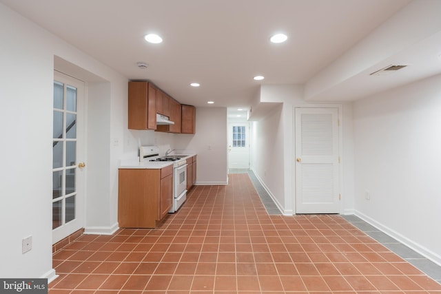 5312 Baltimore Ave, Chevy Chase, MD 20815 - kitchen featuring white gas range oven, under cabinet range hood, light countertops, recessed lighting, and baseboards