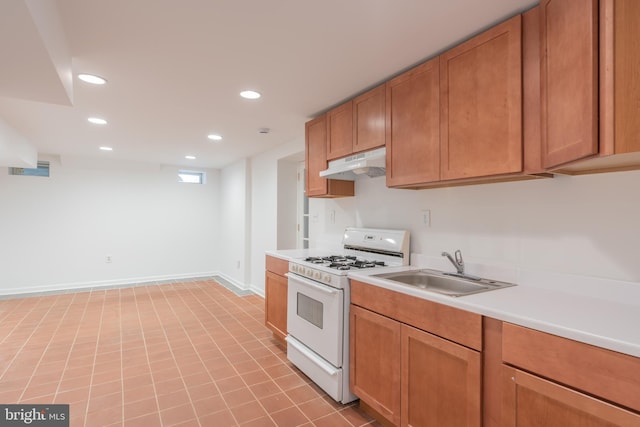 5312 Baltimore Ave, Chevy Chase, MD 20815 - kitchen featuring white gas range, a sink, under cabinet range hood, light countertops, and recessed lighting