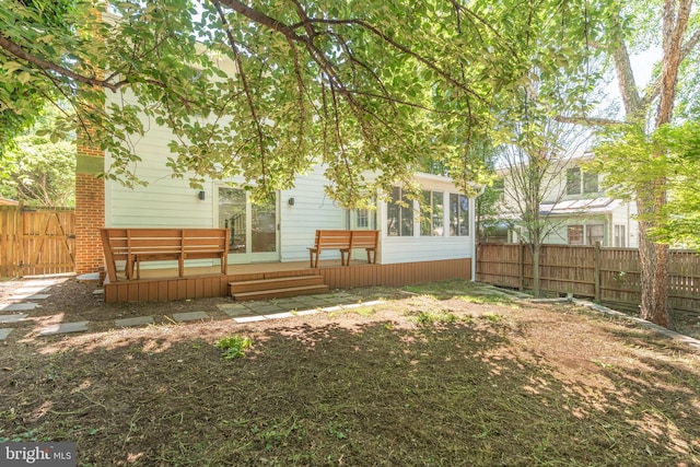 5312 Baltimore Ave, Chevy Chase, MD 20815 - back of property with a sunroom, a fenced backyard, and a wooden deck