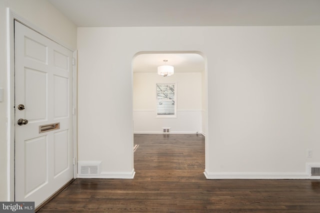 5312 Baltimore Ave, Chevy Chase, MD 20815 - unfurnished room with arched walkways, wood finished floors, and baseboards