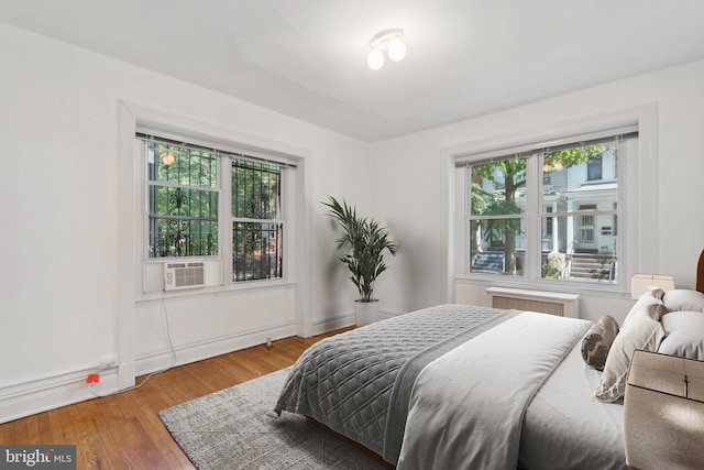 1514 17th St NW Unit 114, Washington, DC 20036 - bedroom with radiator heating unit and wood finished floors