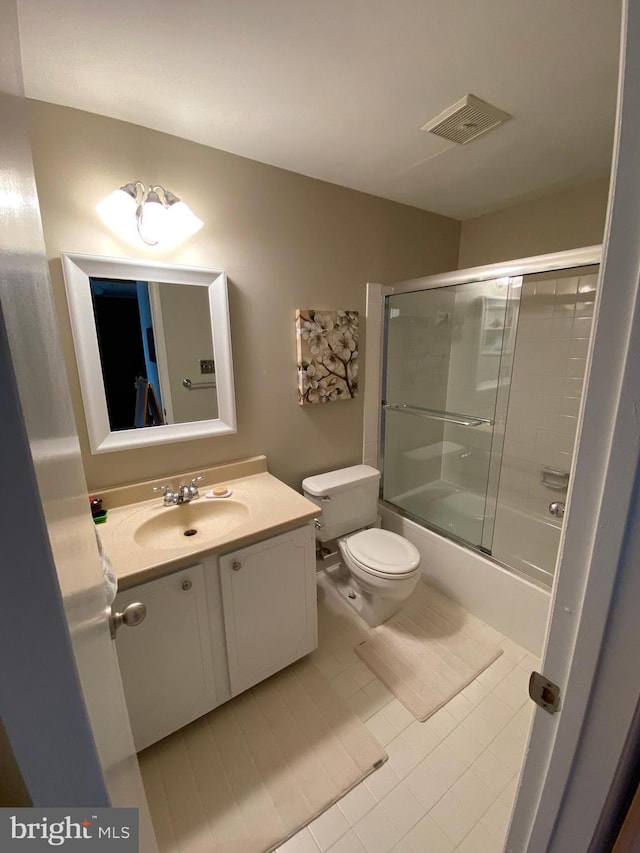 2893 Sutton Oaks Ln, Vienna, VA 22181 - bathroom featuring toilet, vanity, tile patterned flooring, and combined bath / shower with glass door