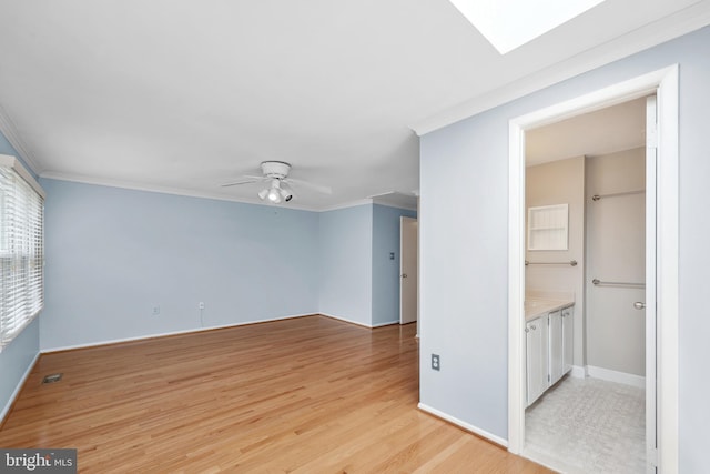 2893 Sutton Oaks Ln, Vienna, VA 22181 - spare room featuring light wood-type flooring, crown molding, a ceiling fan, and baseboards