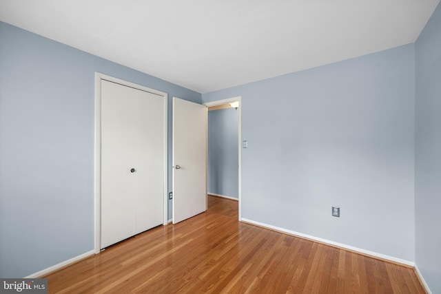 2893 Sutton Oaks Ln, Vienna, VA 22181 - unfurnished bedroom with baseboards, wood finished floors, and a closet