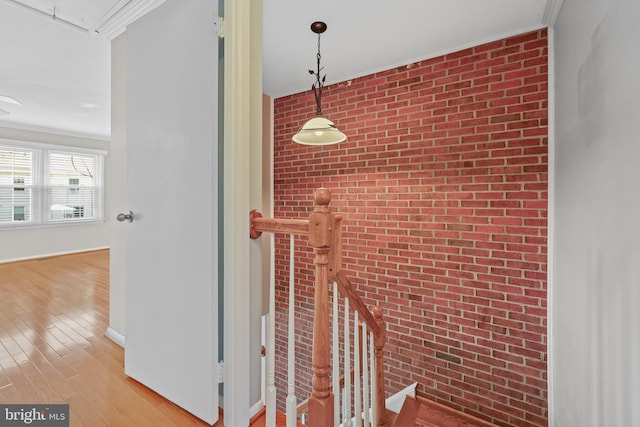 2893 Sutton Oaks Ln, Vienna, VA 22181 - hallway with brick wall, attic access, wood finished floors, crown molding, and baseboards
