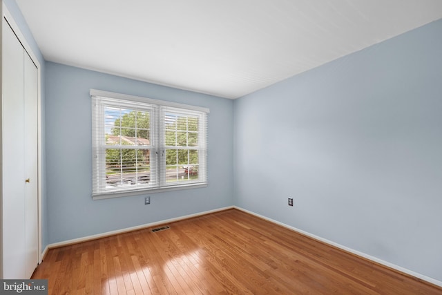 2893 Sutton Oaks Ln, Vienna, VA 22181 - unfurnished bedroom featuring hardwood / wood-style floors, a closet, and baseboards