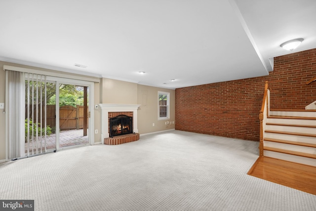 2893 Sutton Oaks Ln, Vienna, VA 22181 - unfurnished living room featuring baseboards, brick wall, stairway, carpet floors, and a brick fireplace