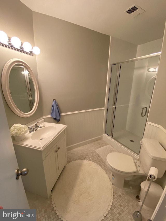 2893 Sutton Oaks Ln, Vienna, VA 22181 - full bathroom with wainscoting, toilet, vanity, a stall shower, and tile patterned floors