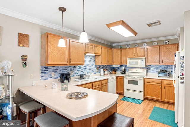 4 Hagarman Dr Unit 4, York, PA 17408 - kitchen featuring white appliances, a peninsula, crown molding, backsplash, and light countertops