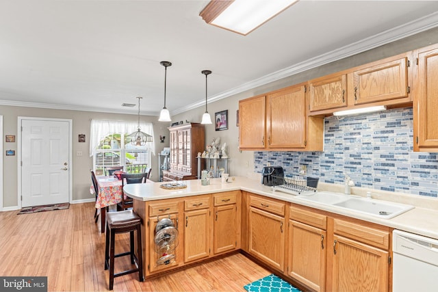 4 Hagarman Dr Unit 4, York, PA 17408 - kitchen with white dishwasher, a peninsula, a sink, backsplash, and light wood finished floors