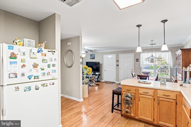 4 Hagarman Dr Unit 4, York, PA 17408 - kitchen featuring freestanding refrigerator, a peninsula, light wood-type flooring, crown molding, and light countertops