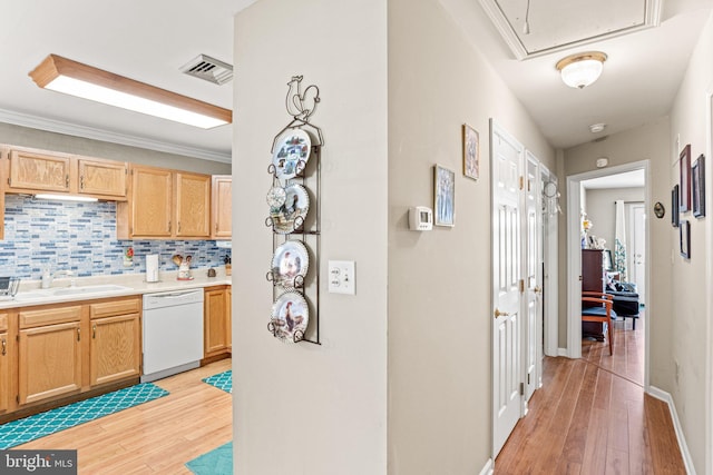 4 Hagarman Dr Unit 4, York, PA 17408 - kitchen featuring white dishwasher, a sink, light wood-type flooring, backsplash, and light countertops
