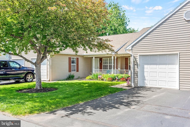 4 Hagarman Dr Unit 4, York, PA 17408 - view of front facade with covered porch, a front yard, a garage, asphalt driveway, and roof with shingles