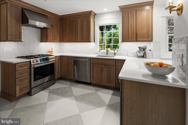 14 Willow Rd, Lawrenceville, NJ 08648 - kitchen featuring stainless steel appliances, wall chimney range hood, a sink, tasteful backsplash, and light countertops