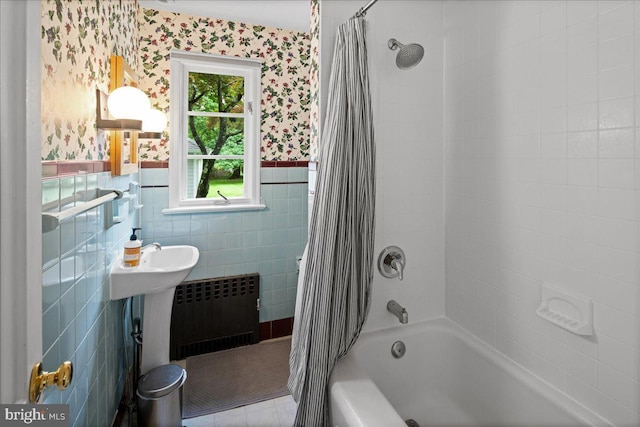 14 Willow Rd, Lawrenceville, NJ 08648 - bathroom with wallpapered walls, radiator, shower / bathtub combination with curtain, a wainscoted wall, and tile walls