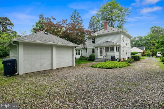 14 Willow Rd, Lawrenceville, NJ 08648 - back of property with a chimney, a detached garage, an outbuilding, entry steps, and roof with shingles