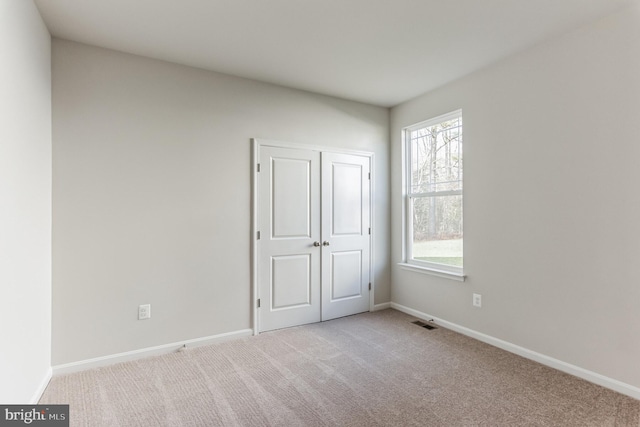 33841 Joel Ln, Lewes, DE 19958 - unfurnished bedroom with carpet floors, baseboards, and a closet