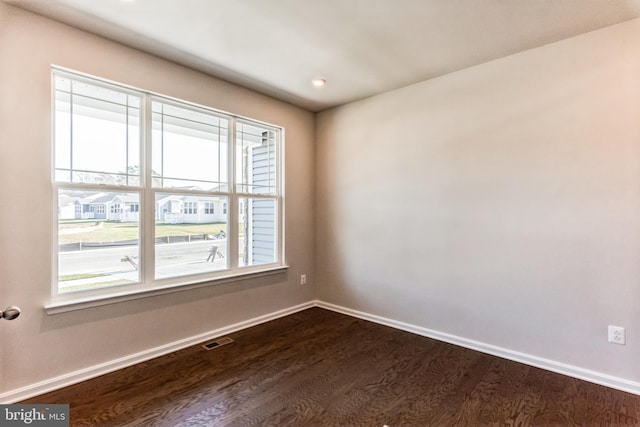 33841 Joel Ln, Lewes, DE 19958 - spare room featuring dark wood-style floors and baseboards