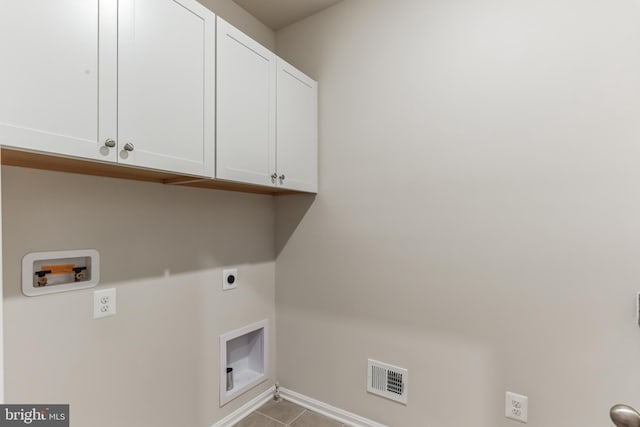 33841 Joel Ln, Lewes, DE 19958 - laundry area featuring cabinet space, hookup for an electric dryer, baseboards, hookup for a washing machine, and tile patterned flooring