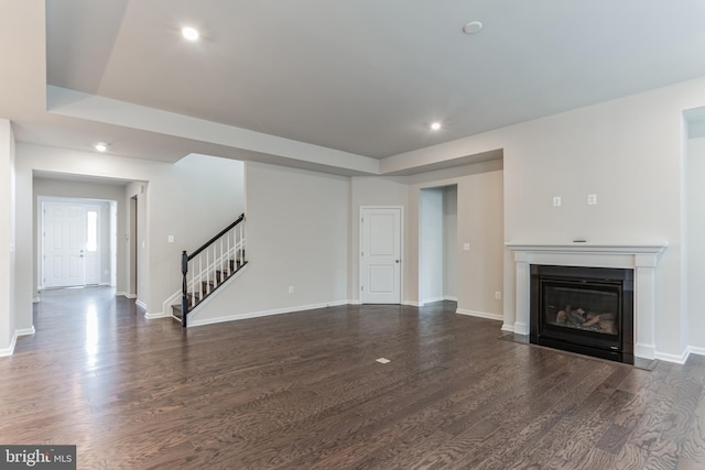 33841 Joel Ln, Lewes, DE 19958 - unfurnished living room with stairway, dark wood-type flooring, recessed lighting, a fireplace with flush hearth, and baseboards