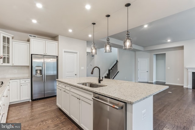 33841 Joel Ln, Lewes, DE 19958 - kitchen with stainless steel appliances, a sink, glass insert cabinets, recessed lighting, and white cabinetry