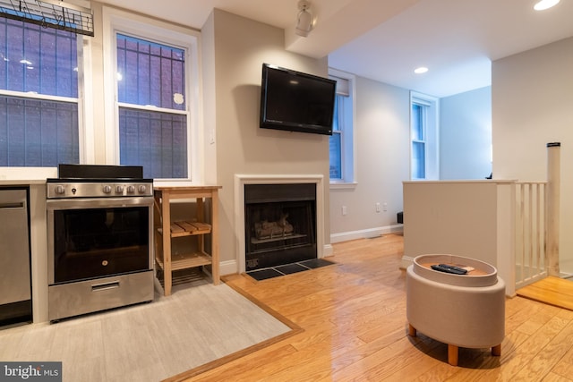 1731 Willard St NW Unit 102, Washington, DC 20009 - living area with wood finished floors, a fireplace with flush hearth, baseboards, and recessed lighting