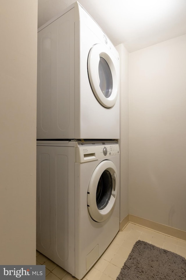 1731 Willard St NW Unit 102, Washington, DC 20009 - laundry area featuring stacked washer / dryer and light tile patterned flooring