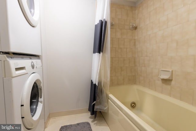 1731 Willard St NW Unit 102, Washington, DC 20009 - full bath featuring stacked washing machine and dryer, tile patterned floors, a combined bath / shower with jetted tub, and baseboards