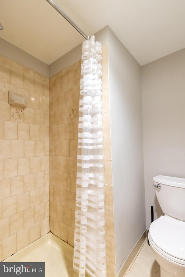 1731 Willard St NW Unit 102, Washington, DC 20009 - bathroom with tiled shower, toilet, and tile patterned flooring