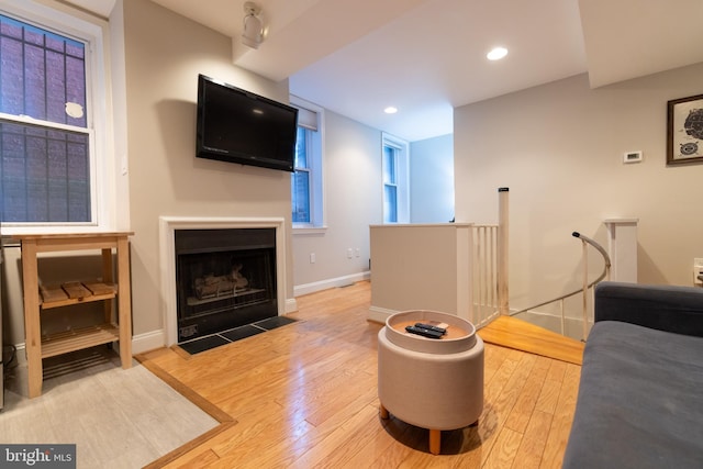 1731 Willard St NW Unit 102, Washington, DC 20009 - living area featuring wood-type flooring, baseboards, a fireplace with flush hearth, and recessed lighting