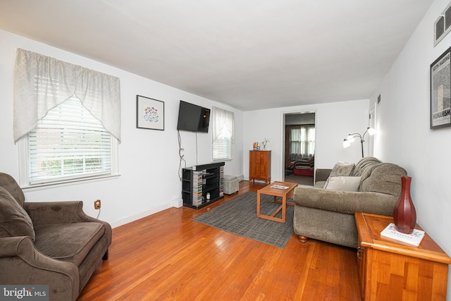 617 March St, Reading, PA 19607 - living room featuring wood finished floors, plenty of natural light, and baseboards