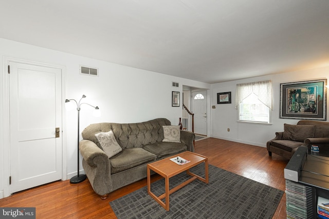 617 March St, Reading, PA 19607 - living room featuring wood finished floors, stairs, and baseboards