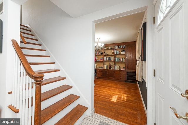 617 March St, Reading, PA 19607 - staircase featuring tile patterned floors and a chandelier