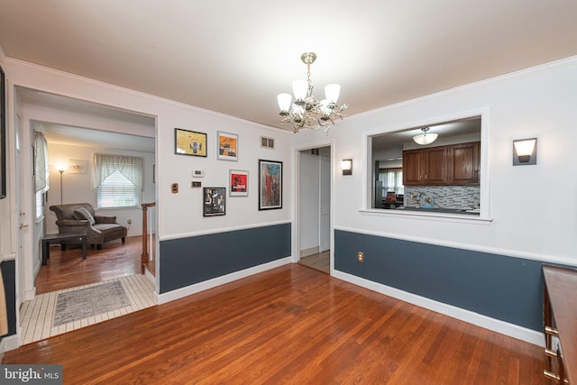 617 March St, Reading, PA 19607 - dining space featuring a chandelier, wood finished floors, ornamental molding, and baseboards
